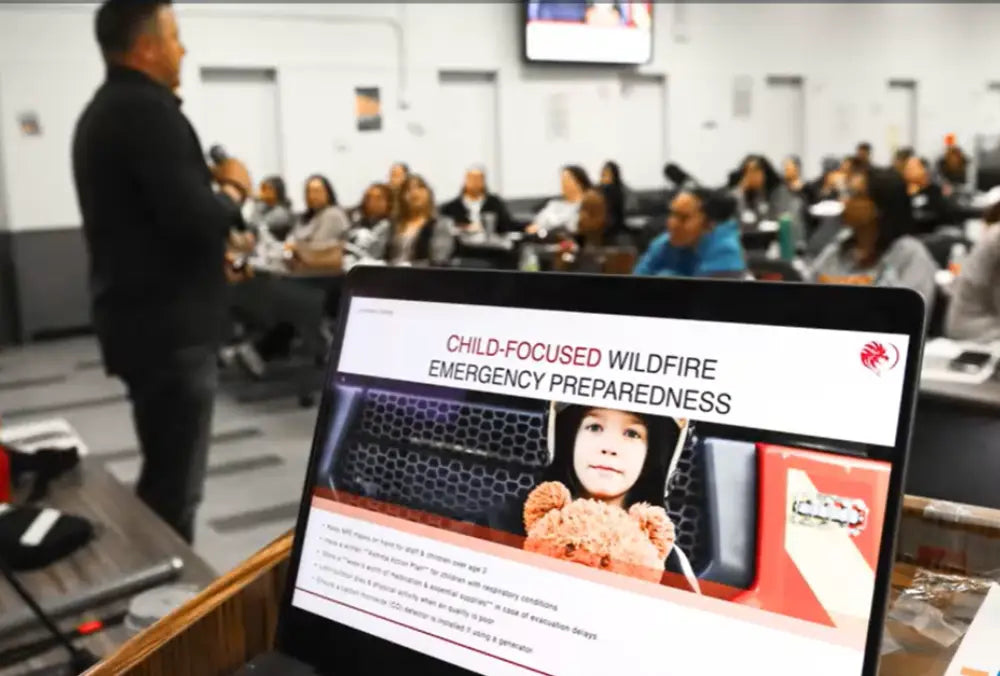 Laptop displaying 'Child-Focused Wildfire Emergency Preparedness' with a classroom setting in the background.