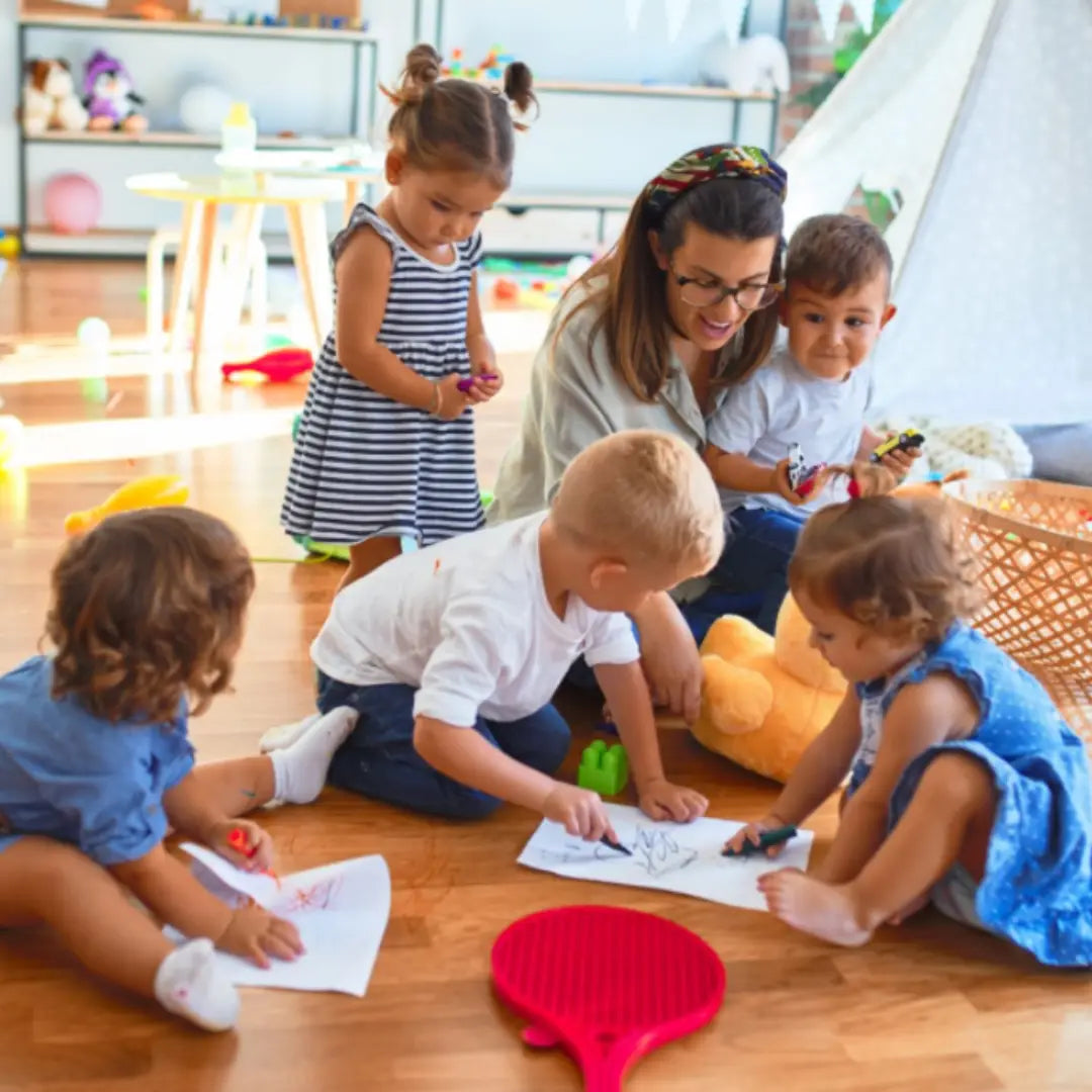 Children and a teacher playing together in a classroom setting