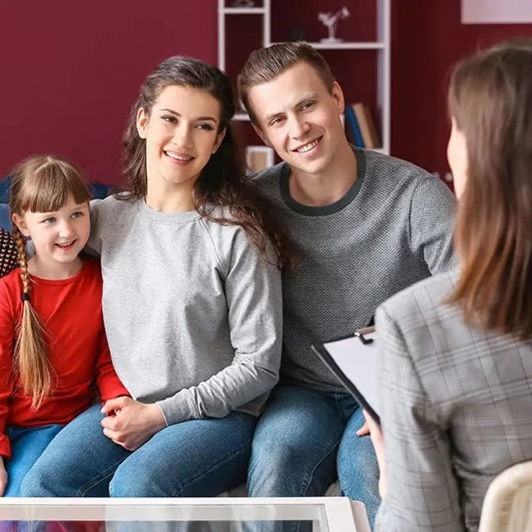 Family sitting with a therapist in a therapy session